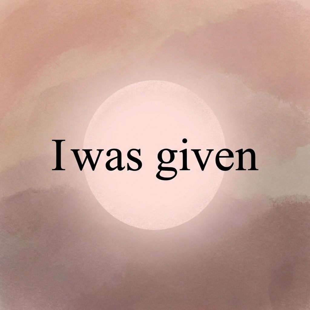 A graphic design featuring the text "I was given" in a black serif font, centered on the image. Behind the text is a soft, glowing white circle resembling a sun or moon. The background is a textured, abstract wash of muted pinks, browns, and beige tones, giving the impression of a watercolor painting or a dusty atmosphere.
